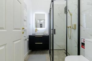 a bathroom with a sink and a shower at Downtown Bucharest Villa Private Garden & Garage for Parking in Bucharest +39 photos