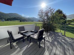 two chairs and a table on a wooden deck at Elizako bidea in Mendive