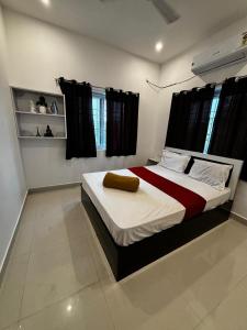 a bedroom with a bed with a red and white blanket at Dreamy beach villa in Pondicherry +41 photos