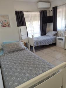 a bedroom with two beds and a window at Backpackers Homestay 21-36 yrs ONLY in Caloundra +10 photos
