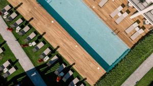 an overhead view of a swimming pool with chairs at New Beach Hotel in Planos +29 photos