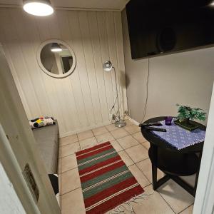 a small room with a table and a bed at Centrala Tanumshede in Tanumshede