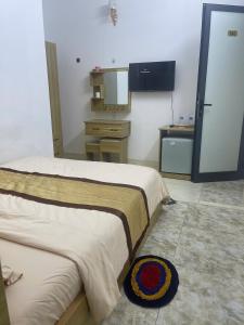 a hotel room with two beds and a television at Lami House in Danang