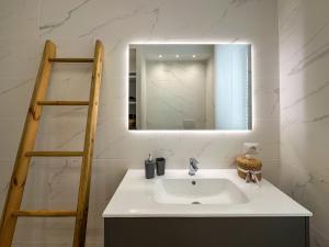 a bathroom with a sink and a mirror at Mamma Oca in Esanatoglia +47 photos