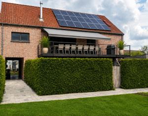 a house with solar panels on the roof at Enjoy Today Panoramic House Koppenberg in Oudenaarde