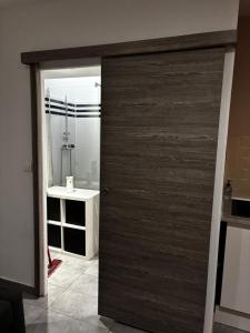 a wooden door in a bathroom with a sink at Aprile in Palavas-les-Flots