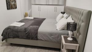 a bedroom with a large bed with white pillows at Apartment Qiu in Costa da Caparica +57 photos