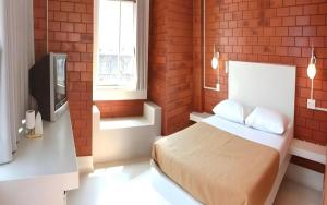 a bedroom with a bed and a television in it at Changsova Hotel in Ban Chang +68 photos