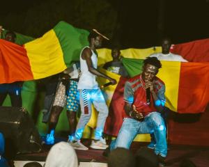 a group of people on a stage with flags at SEN-CASA- TOURiSME in Kabadio