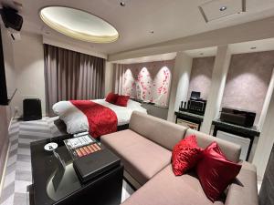 a hotel room with a bed and a couch at ホテル侘 in Himeji