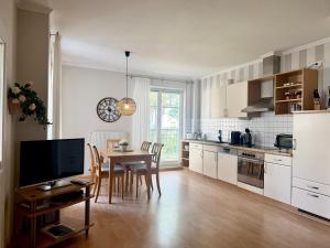 a kitchen with a table and a dining room at Villa Jugendglück in Binz