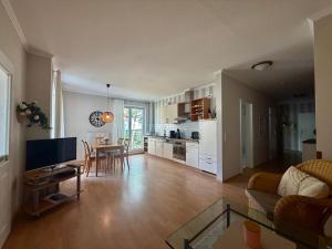 a large living room with a table and a kitchen at Villa Jugendglück in Binz