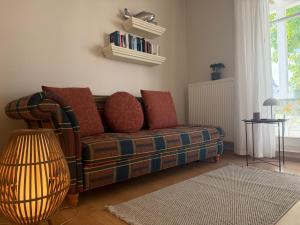 a living room with a couch and a table at Villa Jugendglück in Binz
