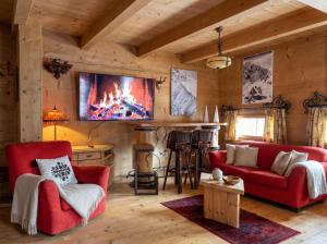 a living room with a fireplace in a log cabin at Golden Tatra Chalet - Fireplace, Sauna & Garden in Zakopane