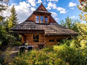 a log cabin with a gambrel roof at Golden Tatra Chalet - Fireplace, Sauna & Garden in Zakopane