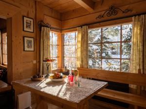a table with a bowl of fruit in a room with a window at Golden Tatra Chalet - Fireplace, Sauna & Garden in Zakopane