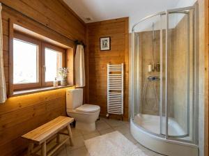 a bathroom with a toilet and a shower at Golden Tatra Chalet - Fireplace, Sauna & Garden in Zakopane +31 photos
