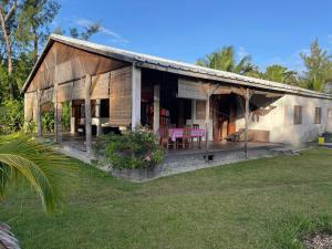 a house with a porch with pink chairs on it at Villa Masoandro in Sainte Marie