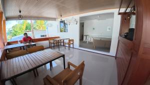 a person sitting at a table in a room at VelaaOlhu - Turtle Hive Thulusdhoo in Thulusdhoo