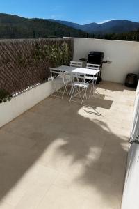 a table and chairs on a patio with a view at Holidays in Sainte-Maxime
