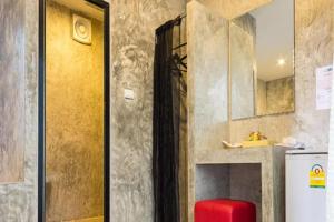 a kitchen with a refrigerator and a red stool at The Rest Hotel in Ko Larn +75 photos
