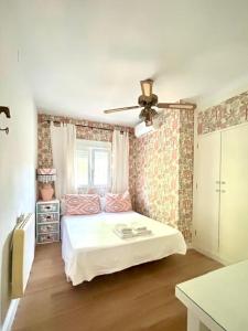 a bedroom with a bed and a ceiling fan at Villa El Carmen in Sanlúcar la Mayor +49 photos