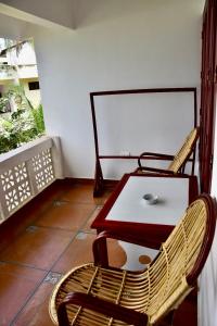 a room with a table and a chair and a table at Buddha Beach Hotel in Kovalam