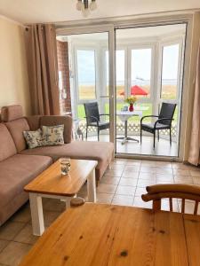 a living room with a couch and a table at Horizont-Wohnung-3 in Cuxhaven
