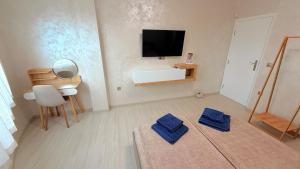 a living room with two blue towels on the floor at Moni Sunset Apartment Balchik in Balchik