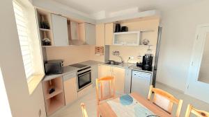 a small kitchen with a table and a dining room at Moni Sunset Apartment Balchik in Balchik