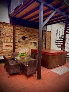 a patio with a table and chairs and a hot tub at Apartment Martinec in Nové Město nad Metují