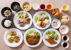 a group of plates of food on a table at Super Hotel Namba Nipponbashi in Osaka