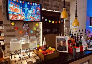 a bar with bottles of alcohol and fruit on a counter at Super Hotel Namba Nipponbashi in Osaka