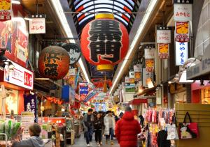 a group of people walking through a shopping mall at Super Hotel Namba Nipponbashi in Osaka +86 photos