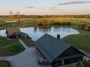 an aerial view of a house and a lake at Milžinai Retreat in Zarasai