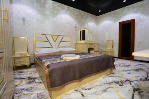 a bedroom with a large bed and a mirror at Family Hotel in Khujand
