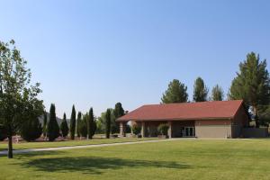 a large building with a grass field and trees at Verde Valley Tiny House 17 in Cottonwood