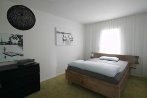 a bedroom with a bed and a window at Forellenhof in Nordhastedt +56 photos