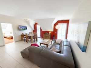a living room with a couch and a table at Haus Sonne - Whg 08 in Thiessow +23 photos
