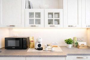 a kitchen counter with a microwave with a hello kitty on it at Suite 21 - Residence Contini in Falconara Marittima