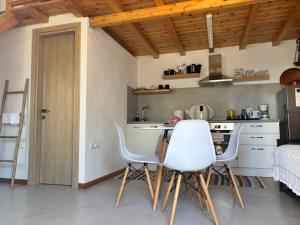 a kitchen with a table and chairs in a room at To Katinaki in Trikeri +6 photos
