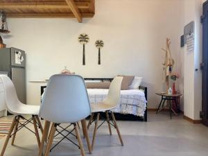 a bedroom with a bed and a table and chairs at To Katinaki in Trikeri