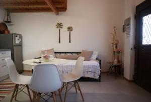 a room with a bed and a table and chairs at To Katinaki in Trikeri