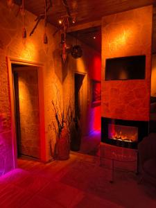 a living room with a fireplace with red and purple lights at GLS Priamos in Piraeus