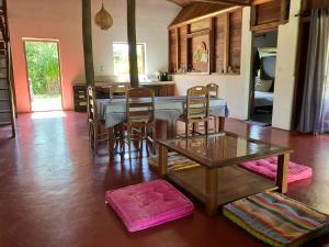 a room with a table and chairs and a kitchen at Villa Masoandro in Sainte Marie