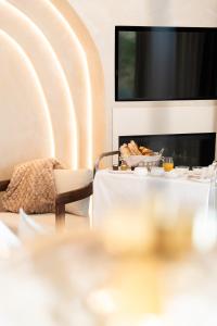 a table with a bowl of food and a television at La Bastide des Rameaux - Boutique Hôtel & Spa in Callas