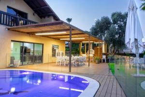 a house with a swimming pool in front of a building at Villa Sun Bay in Eilat