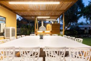 a white table and chairs under a wooden pergola at Villa Sun Bay in Eilat