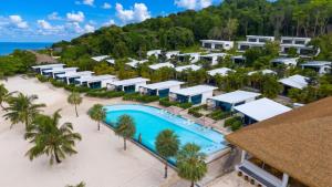 an aerial view of a resort with a pool and palm trees at The One Resort in Koh Rong Island