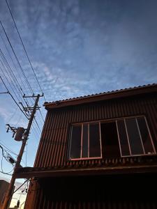 a window on the side of a house at HOTEl MOTO in Oshima